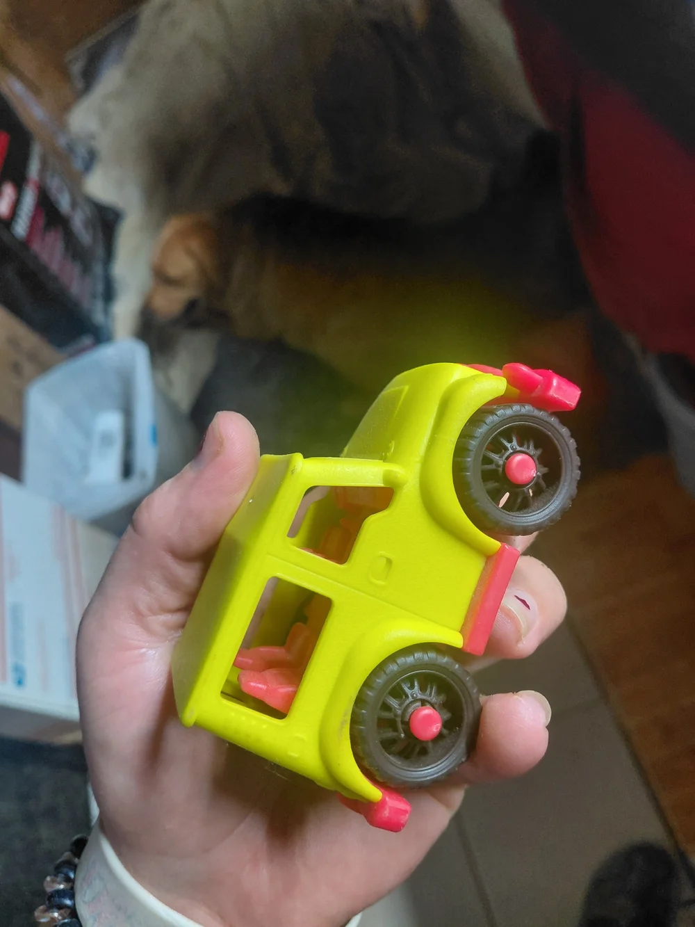 yellow toy vehicle is a B. toys Happy Cruisers Mini 4x4, featuring chunky wheels